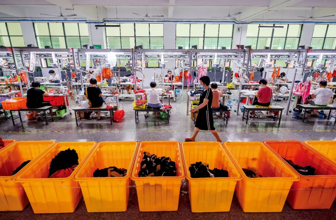 2021年9月28日，福建晋江一家泳装厂，工人在生产线上赶制出口欧美的订单。图/视觉中国