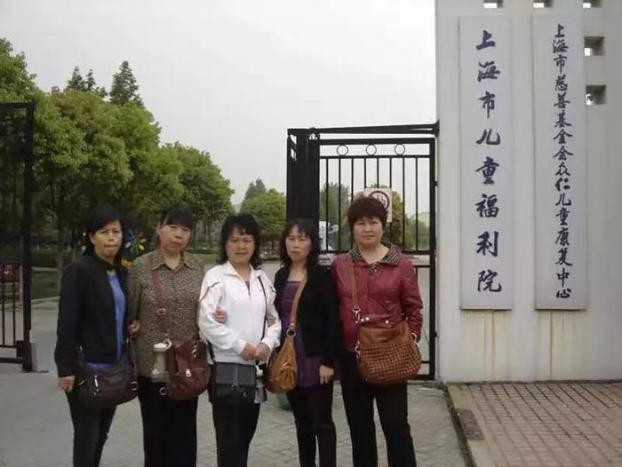 姚会芳（右二）与其他寻亲人在上海市儿童福利院门口合影，照片拍摄于2008年、2009年左右。